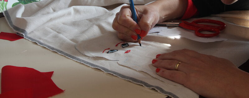 Marina — hands working on fabric, creating the baby doll pattern